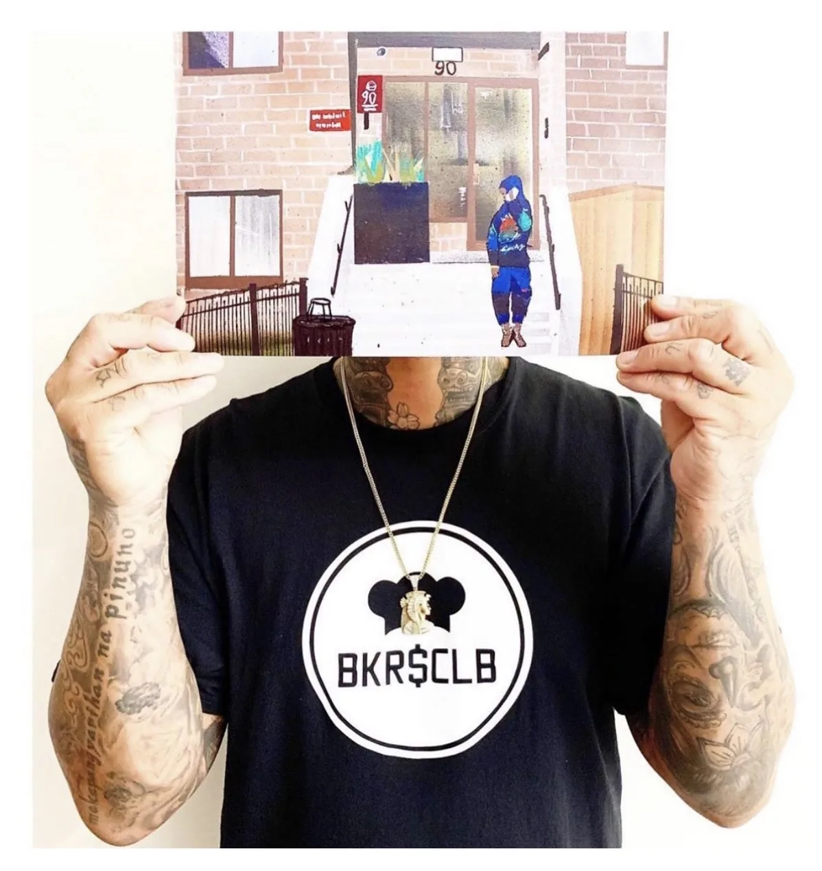 A person in a BKRSCLB shirt holding a finished No Deal Peel print